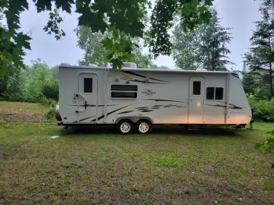Great condition and was re-sealed top to bottom at end of 2025. Hardwood cabinets, full queen size b...