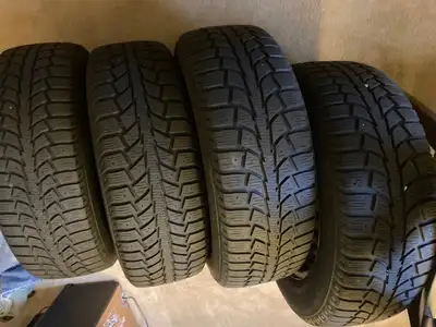 Four used Uniroyal winter tires (on rims) for sale, sized 195/65R15.