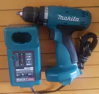 Makita Drill and model DC1414T Charger. (no battery)