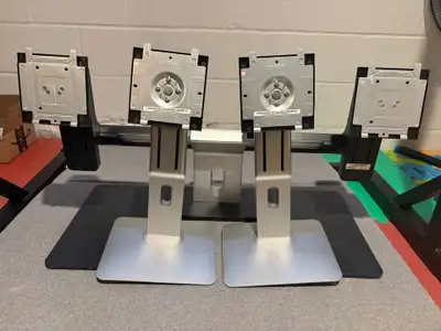 Selling a set of three (3) high-quality, professional-grade Dell monitor stands (2 silver base, 1 bl...