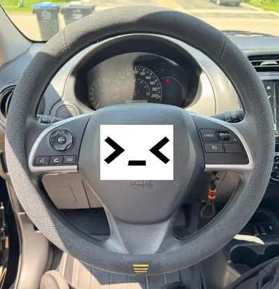 Spruce up your driving experience with this stylish black steering wheel cover! It's designed with a...