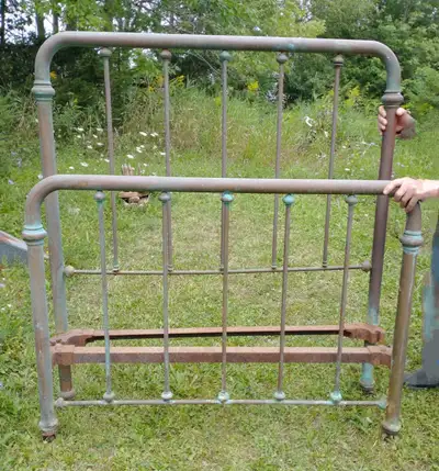 Antique brass bed headboard and footboard. No siderails. Corroded and tarnished and could be restore...