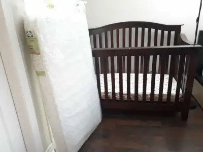 Crib with new mattress and several sheets, View more