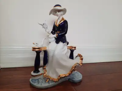 A magnificent porcelain figurine with a refined glaze, richly decorated in deep cobalt and elegant g...