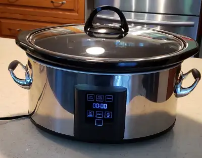 Slow cooker features multiple heat settings and touchscreen control. Measures 16.5in x 8.5 in x 12 i...