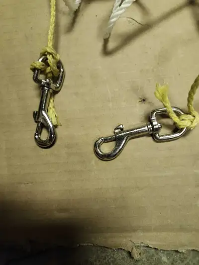 TWO 20 FT LONG NYLON ROPE TETHERS. ONE END HAS GOOD CLOSURE ROTATING WEATHERPROOF CLIP IN SNAP. OTHE...