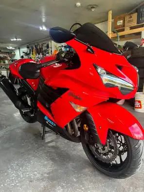 Feast your eyes on this vibrant red Kawasaki zx14r Ninja, a true powerhouse on two wheels! While it...