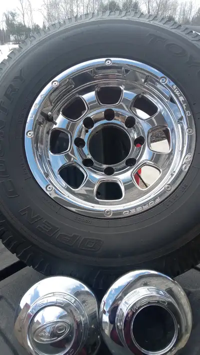 Four tires and rims . 4 weld forged EVO rims with Toyo A/T open country tires on them. LT 265 75R16...