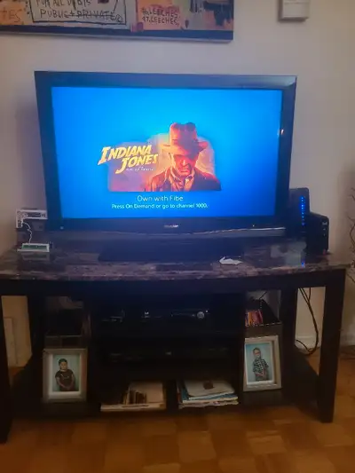 TV + Stand. Good condition. Stand is concaving but still holding up. Good for basement or additional...
