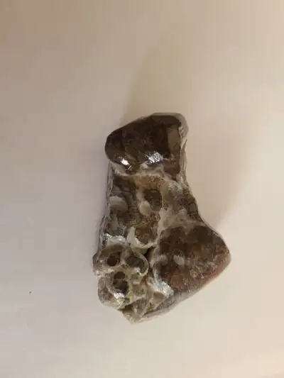 Fire agate measures approximately 2 1/2 inches x 1 to 2 inches and approximately 1/2 inches thick. P...