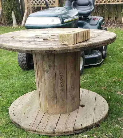 Solid Wooden utility spool for outdoor projects...large.. Refer to picture with brick for sizing......