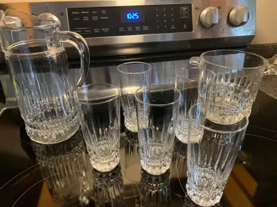 A set of Cristal glass with a pitcher, an ice holder and five tall glasses asking $40