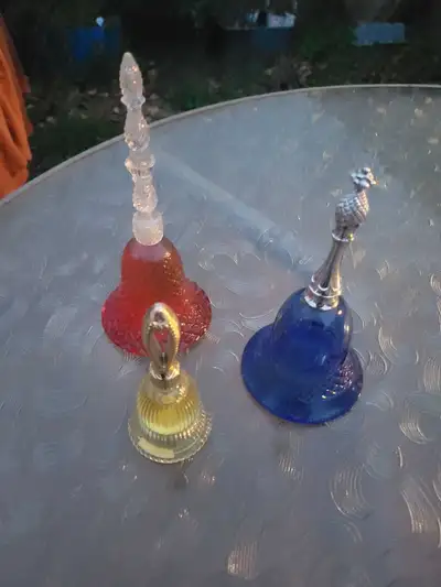 These 3 bell bottles of Avon fragrance are sold as a lot.