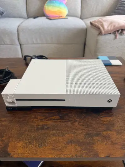 White Xbox One S with a silver controller. Excellent working condition. Can run disks and watch movi...