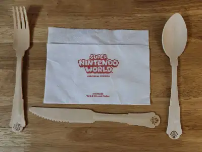 I'm selling a Super Nintendo World wooden cutlery set! This includes a fork, knife, spoon, and napki...