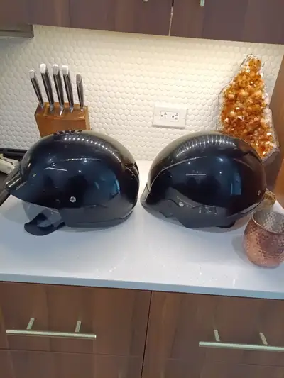 2 helmets one large one medium. Half helmets with pull down tinted visors. Will sell both for 125 do...