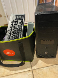 Computer with keyboard and box assorted cables and electronics