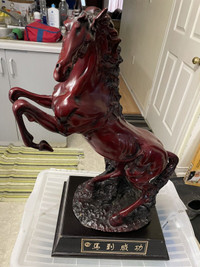 Red/  brown wooden horse on stand