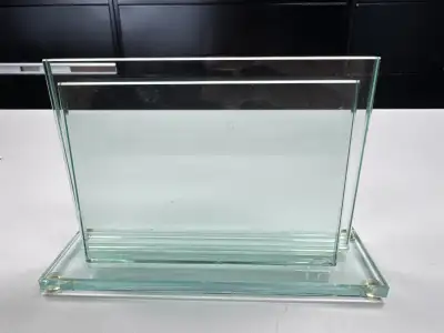 This is a clear glass picture frame or award holder. Made from clear plexiglass construction. Featur...