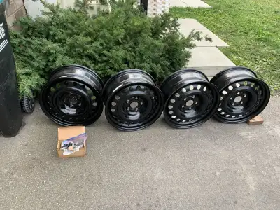 17-inch steel rims off a Honda Ridgeline, featuring a 5x120 bolt pattern. The rims include lug nuts...