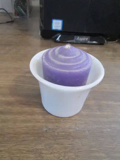 tea candle holder with purple tea candle., View more