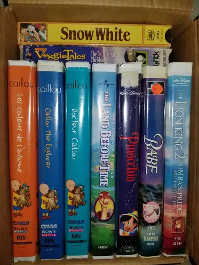 3 Caillou tapes, classic Land Before Time and Babe. Classic Snow White, Disney's Pinocchio and The L...