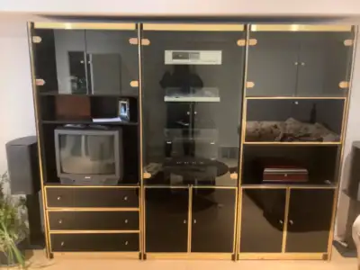This is high gloss black and gold metal finish wall unit, entertainment centre. There are 3 sections...