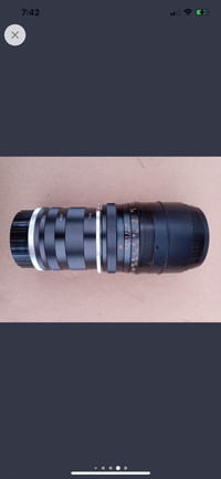 Kitstar 135 mm SLR lens with case.