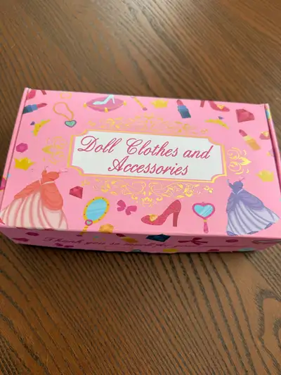 A new Barbie doll clothes and accessories. The set includes a variety of outfits, shoes, and accesso...