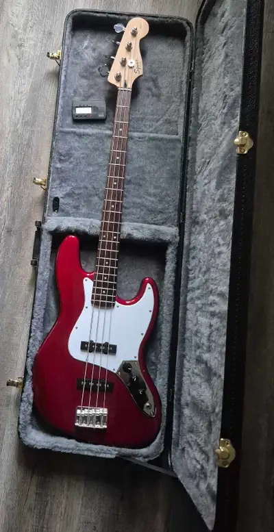 Squire Affinity J bass with hardshell case and tuner. Has a few scratches (see pictures) but is in w...
