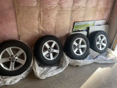 4 winter tires on factory VW rims in excellent condition. Tire size: 215/65 R 16 Bolt Spacing: 5x112...