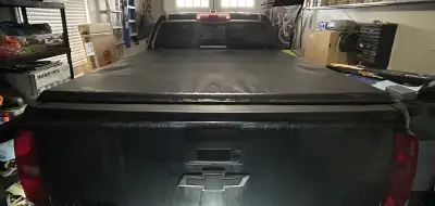 Soft, trifold tonneau cover from a 2020 Chevrolet Colorado (5'-2" box). Small tear on it has been re...