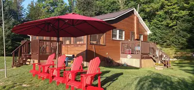 Family cottage available for rent on a large, picturesque lot on the shores of the Irondale river, i...