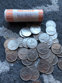 Full roll of 1969 Canadian quarters. Coins
