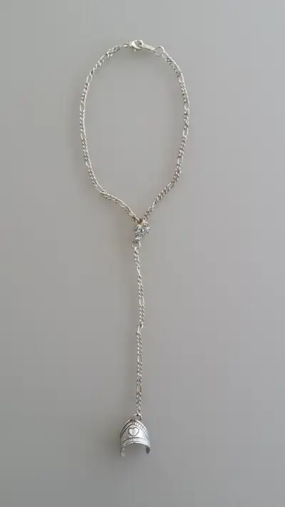 Child's new combination anklet and toe ring. Ornate chain with a silver coloured metal toe ring. The...