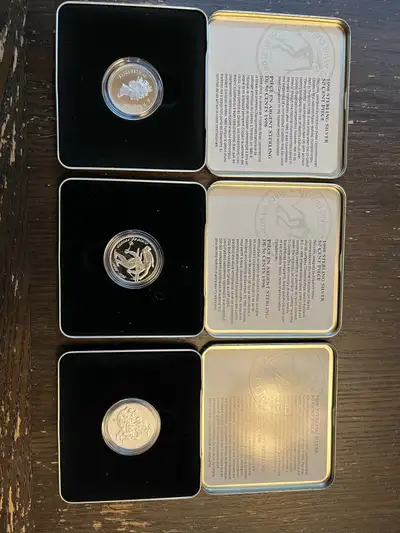 Set of three 1998 50 cents coins from the Royal Canadian Mint’s “Canadian Sports Firsts” series. Coi...
