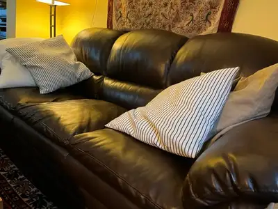 Comfortable, cappuccino brown faux leather couch. Some wear and tear from moving as shown in photos...