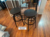 Two wood and black steel tall stools