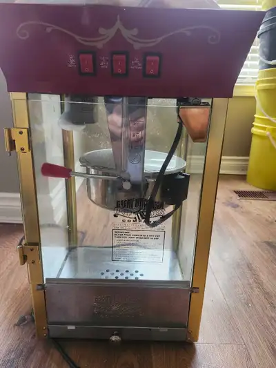 Retro-style popcorn machine with a warmer, stirrer, and pot heater. Includes operating instructions...