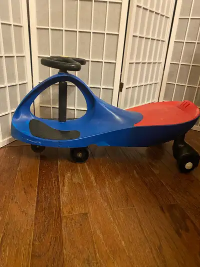 Zoom around the house or driveway on this gently used PlasmaCar wiggle car ride-on toy, featuring a...