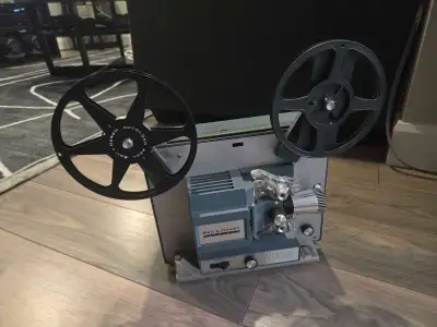 This is a vintage Bell and Howell 8mm projector, perfect for displaying those old home movies! It's...