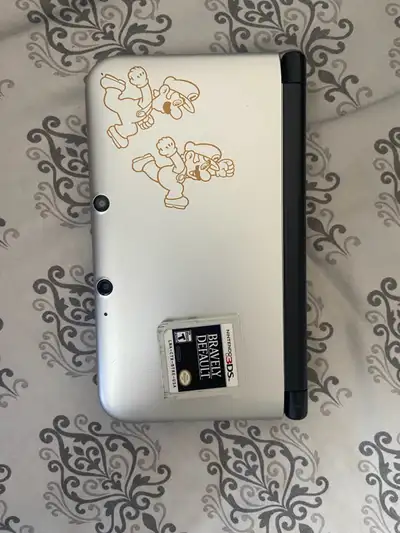 Nintendo 3DS XL Mario and Luigi Dreamteam. Still works in good condition and comes with the game bra...