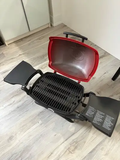 Almost new Weber Q 1200 Portable Liquid Propane BBQ in Black. Used a couple of times. Cover included...