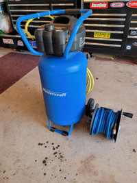 Air compressor with hose reel