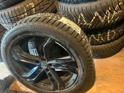 Set of four 235/50 R19 Bridgestone Blizzak winter tires on glossy black rims (5x108)