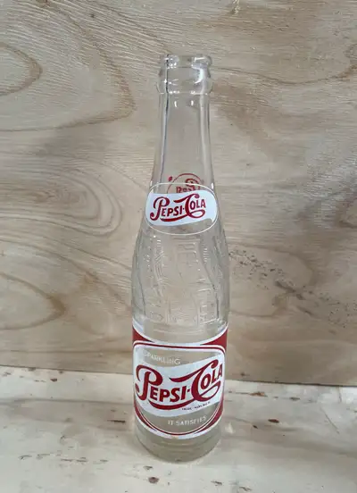 In WEYBURN 3 Collectible Pepsi bottles 1951, 53’ label faded, 56’ has small chips on bottom edge $10...