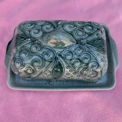 This is a beautiful Spanish gray pottery butter dish featuring intricate designs. It's a unique piec...