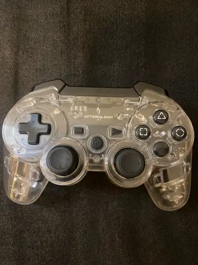 This is a used Afterglow PlayStation 3 controller with a cool clear plastic shell, ensuring you see...