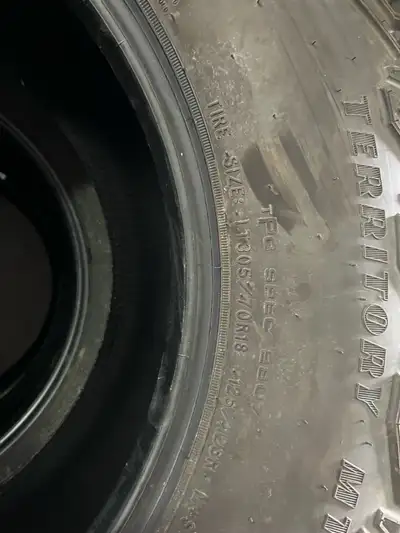 These are Goodyear Wrangler Territory MT tires, size LT305/70R18, perfect for your off-road adventur...