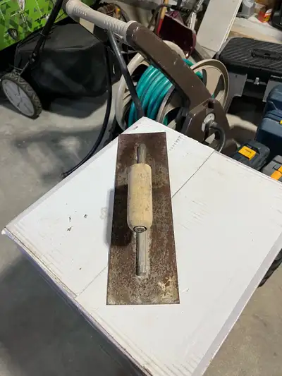 This sturdy, used plastering trowel is perfect for your next drywall or stucco project, featuring a...